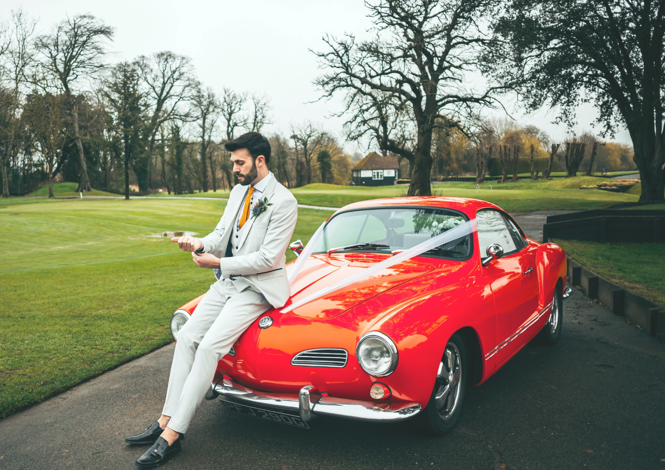 Groom with vintage sports car